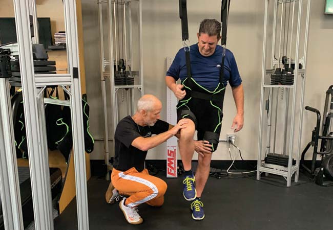 Monty is working with Mike to build strength in his leg while unweighted.